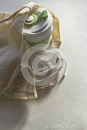 Cotton shopper bag with collapsible silicone eco mug and reusable fruit pouch Stock Photo