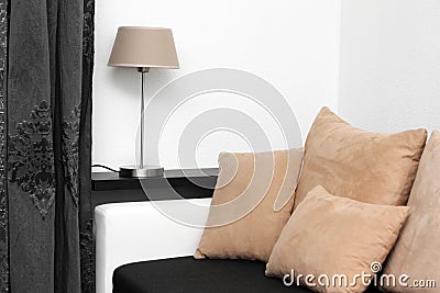 Couch with pillows and lamp on the shelf Stock Photo