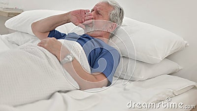 Coughing Sick Senior Old Man Lying in Bed Stock Photo