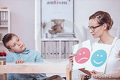Counselor teaching autistic kid Stock Photo