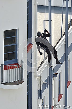 Counter-terrorism police officer abseiling a building Editorial Stock Photo