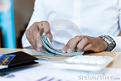 Counting money, businessmen have analyzed between cash and credit card Stock Photo