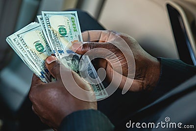Counting paper money. Close-up of a man's hands counting dollar bills. The concept of earnings and business Stock Photo