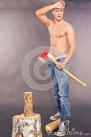 Country boy whittling with an axe Stock Photo