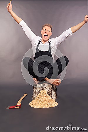 Country bumpkin rejoicing after chopping wood Stock Photo
