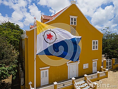 Country Flag of Bonaire Island in the Caribbean waving in front of the office of Lieutenant Governor. Editorial Stock Photo