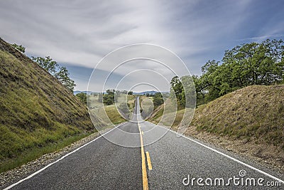 Country highway leads to the horizon Stock Photo