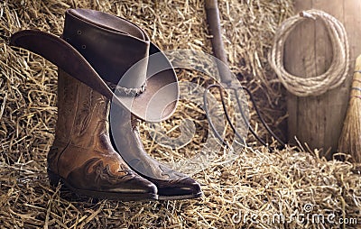 Country music festival live concert or rodeo with cowboy hat and boots in barn Stock Photo