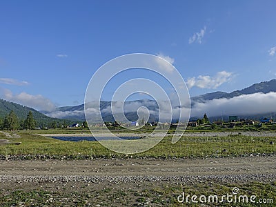 Country road along the river high in the Altai mountains. Stock Photo