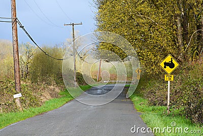 Country road in America with farming signpost Stock Photo