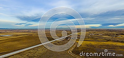 Country road through farm and ranch land Stock Photo