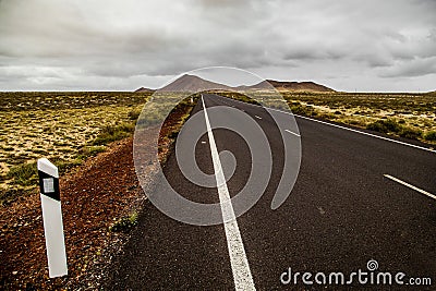 Country road between volcanic landscape Lanzarote Canary Islands Spain Stock Photo