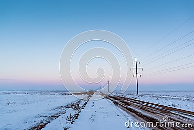 Country road through the winter empty fields Stock Photo