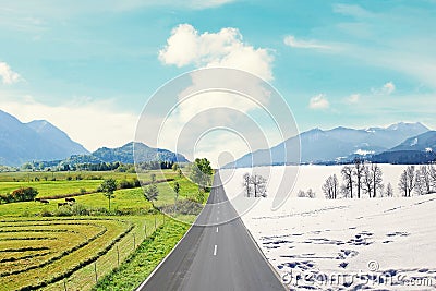 Country road through winter and spring landscape Stock Photo