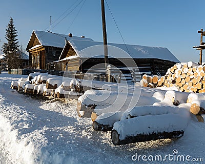 Country street in winter. Snow-covered old log houses. Visim, Sverdlovsk region, Russia Stock Photo