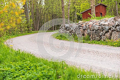 Countryroad with a stonewall, Sweden Stock Photo