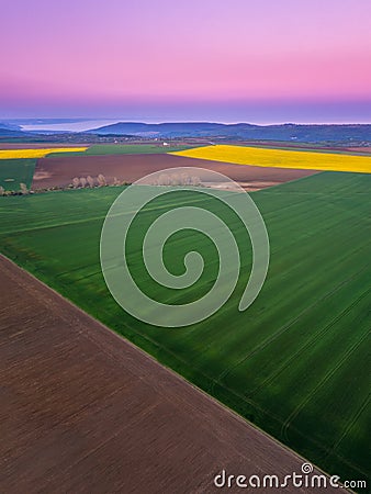 Countryside with green and yellow spring fields Stock Photo