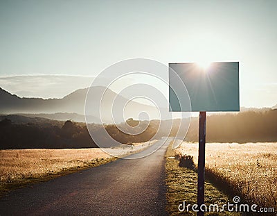 Countryside road ahead and blank defocused sign on the side Stock Photo