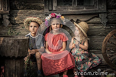 Countryside rustic lifestyle children sitting together old countryside house symbolizing kids friendship and happy carefree rusti Stock Photo