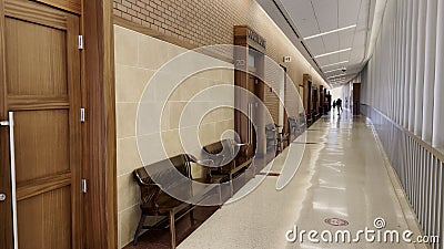 County courthouse interior hallway and seating benches along wall Stock Photo