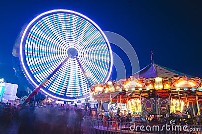 County Fair at night Ferris Wheel on the Midway Stock Photo