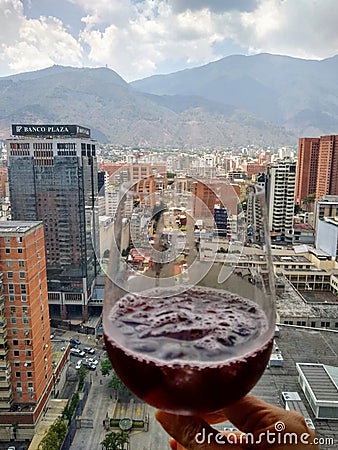 Cup of Spanish drink cocktail sangria overlooking Caracas city with famous El Avila mountain in the backgound Editorial Stock Photo
