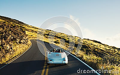 Coupe Driving on Country Road in Vintage Sports Car Stock Photo