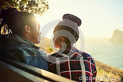 Couple of African descent sitting on a public viewpoint bench Stock Photo