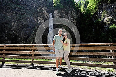 Couple against waterfall in Liechtensteinklamm or Liechtenstein Gorge, Austria Stock Photo