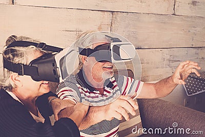 Seniors couple at home trying goggles headset Stock Photo