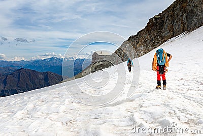 Couple alpinists mountaineers walking glacier slopes. Mont Blanc Stock Photo