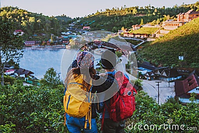 Couple Asian traveling together on mountain in countryside. Enjoying a looking at sunset, Romantic couples Stock Photo