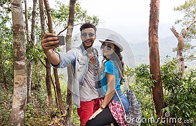 Couple With Backpacks Take Selfie Photo Over Mountain Landscape Trekking, Young Man And Woman On Hike Tourists Stock Photo