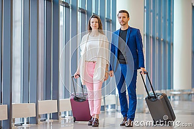Couple with baggage in international airport. Man and woman going on landing Stock Photo