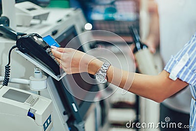 Couple with bank card buying food at grocery store or supermarket self-checkout Stock Photo