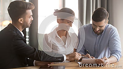 Couple and bank representative reach agreement signing loan contract Stock Photo