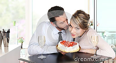 Couple at the bar with sparkling wine and cake, love conce Stock Photo