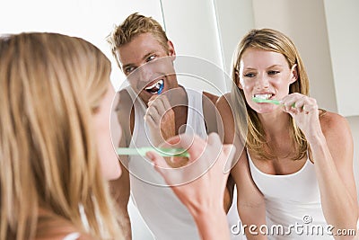 Couple in bathroom brushing teeth Stock Photo