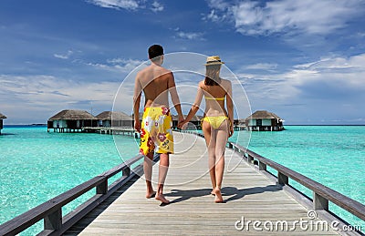 Couple on a beach jetty at Maldives Stock Photo