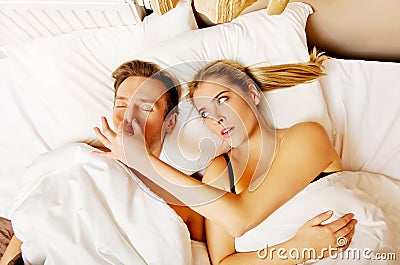 Couple in bed,man snoring woman can't sleep Stock Photo