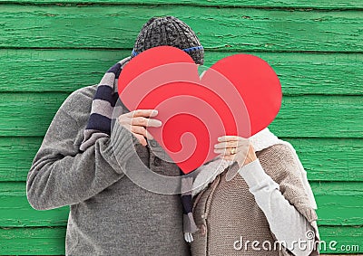 couple behind the heart with green wood background Stock Photo