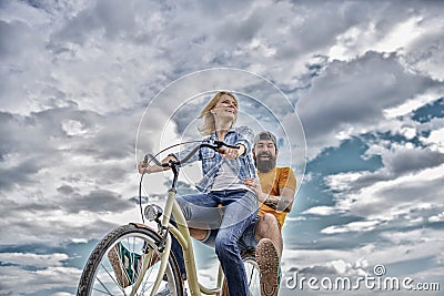 Couple with bicycle romantic date sky background. Psychology of relationships. Leadership in family and marriage. Girl Stock Photo