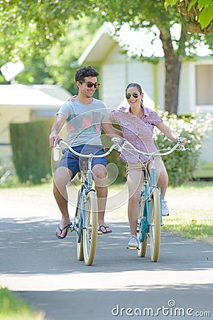 couple biking around campsite Stock Photo