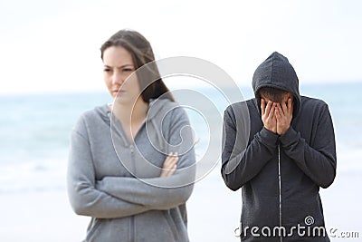 Couple break up on the beach with a girl leaving man Stock Photo