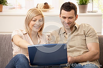 Couple browsing internet on laptop Stock Photo