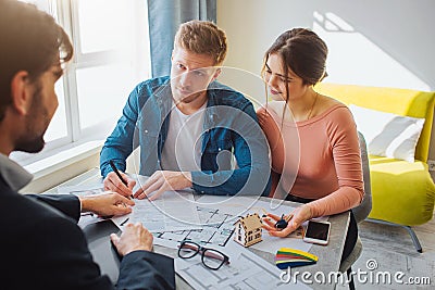 Couple buy or rent apartment together. Business deal. Young man put signature on documents and look at realtor. He point Stock Photo