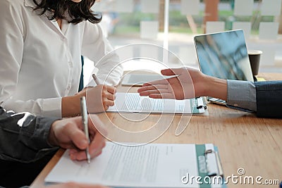 Couple buying renting house car signing mortgage insurance purchase order contract agreement with realtor real estate agent Stock Photo