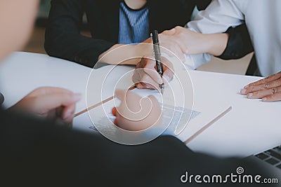 Couple buying renting house signing mortgage contract agreement with realtor real estate agent Stock Photo