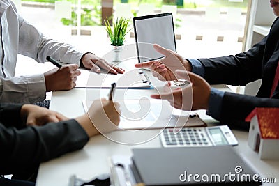 Couple buying renting house signing mortgage contract agreement with realtor real estate agent Stock Photo