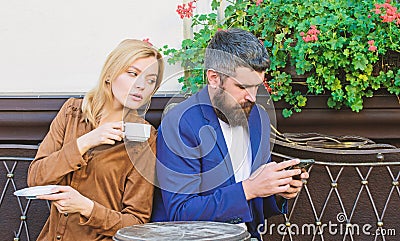 Couple cafe terrace drink coffee. Couple in love sit cafe terrace enjoy coffee. Man secret messaging cheating on wife Stock Photo